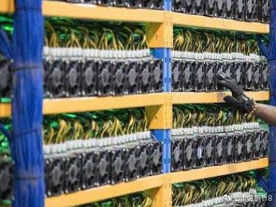 Aerial view of a large-scale cryptocurrency mining farm with rows of buildings and cooling infrastructure